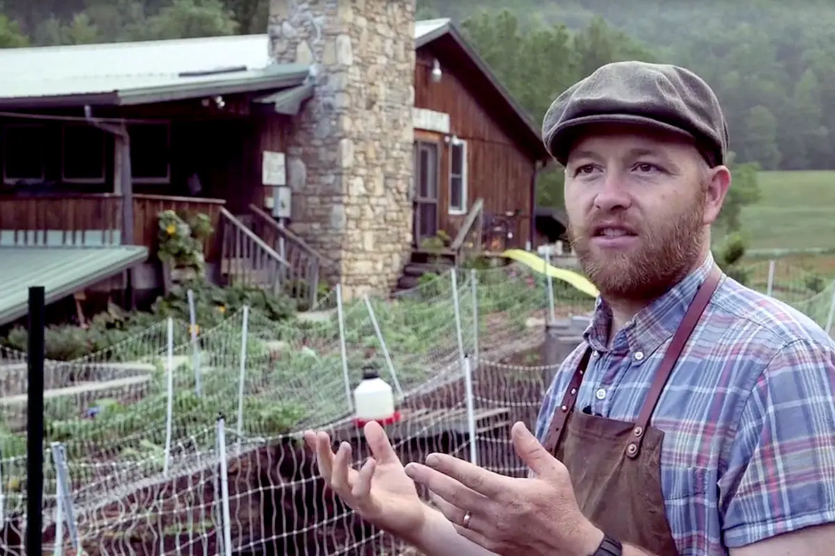 Justin in front of his farm 