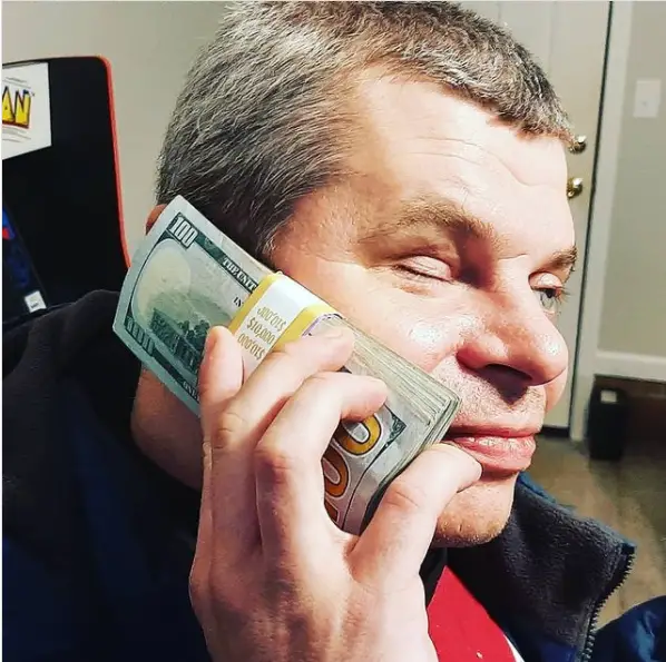 Blind Fury holding cash in his hand