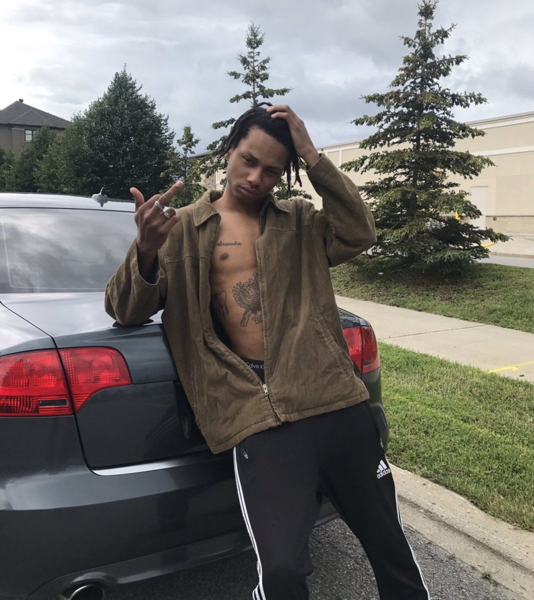 Night Lovell posing in front of one of his cars