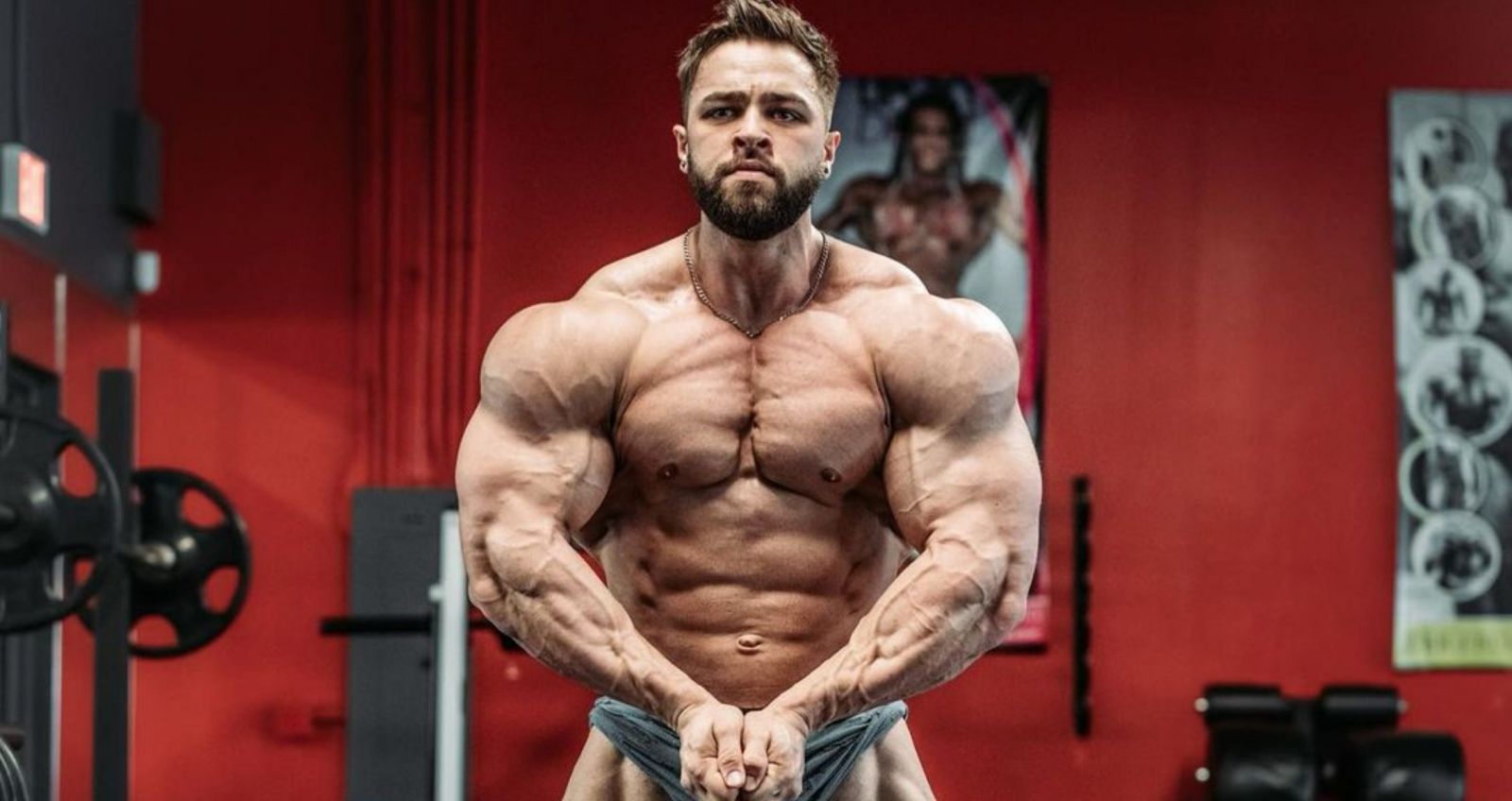 Regan Grimes posing to display his muscular build