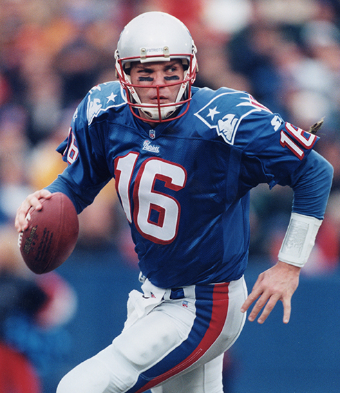 Scott Zolak wearing a Patriots Alumni jersey on the field 
